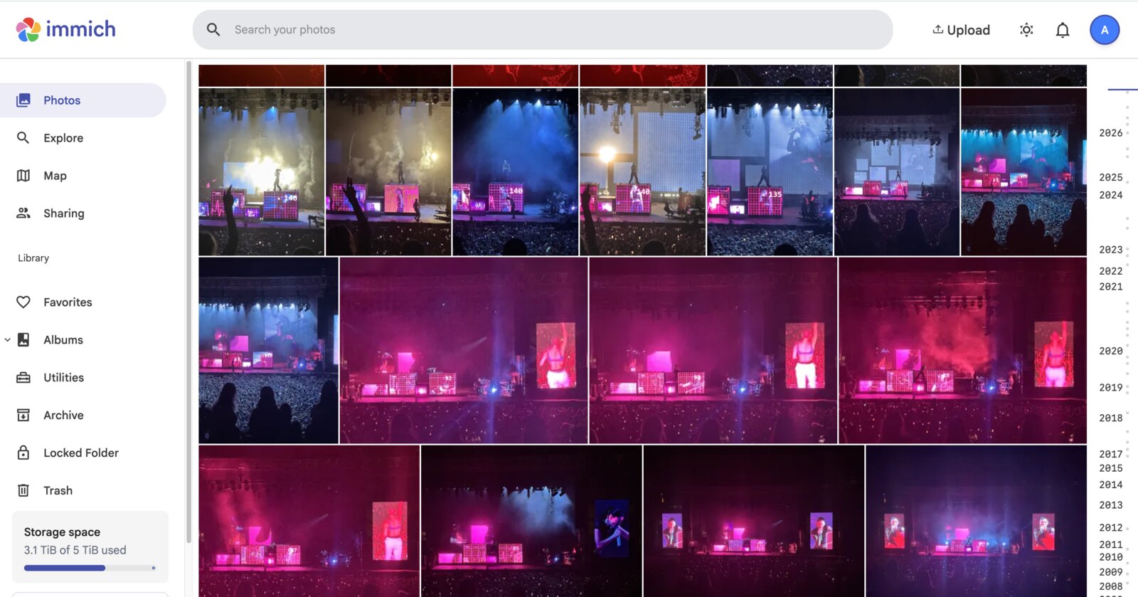 Immich photo library showing a grid of concert photos and a timeline of years